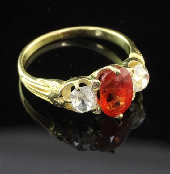 A gold and three stone orange sapphire and diamond ring, size O.